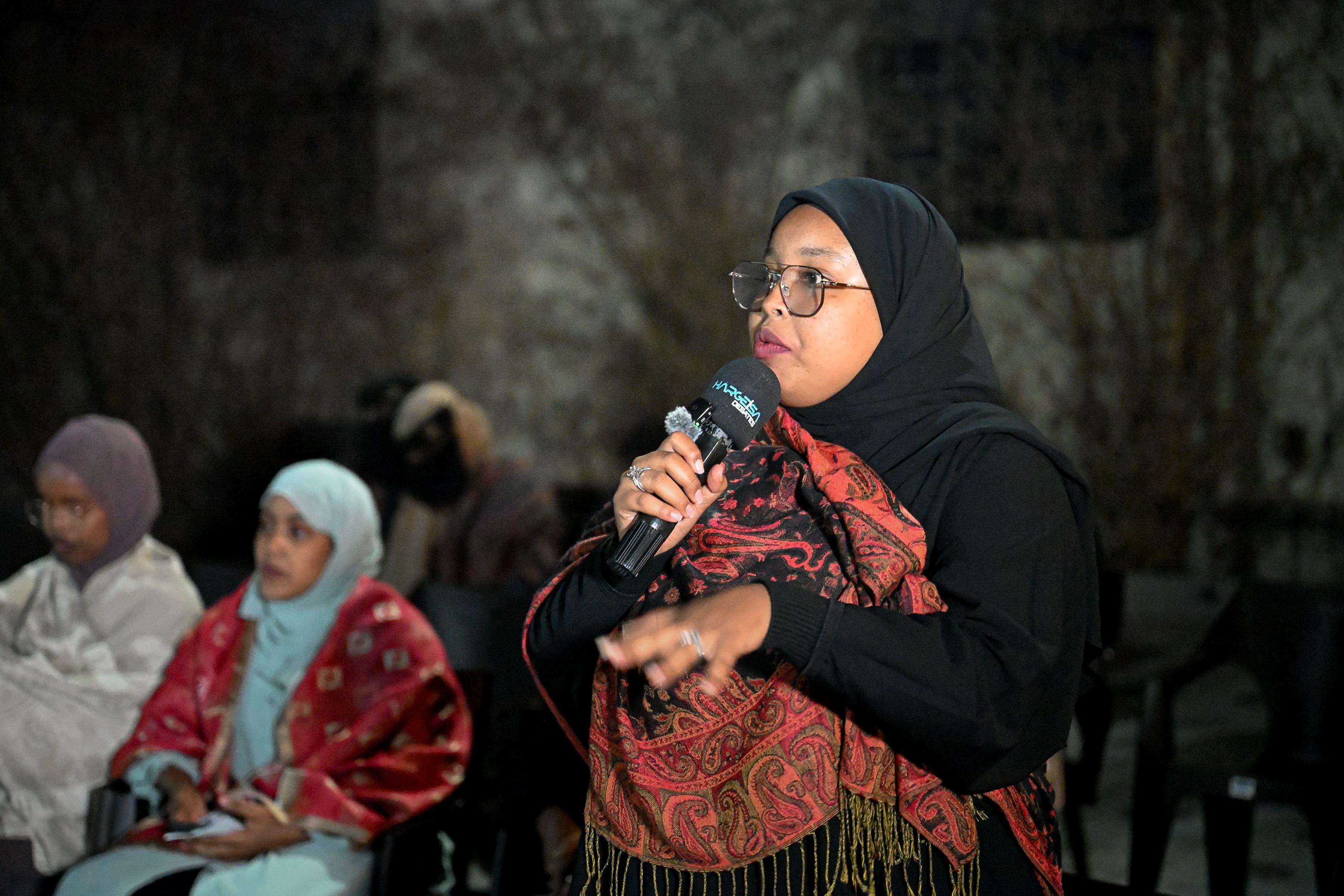 A woman speaking during the audience discussion