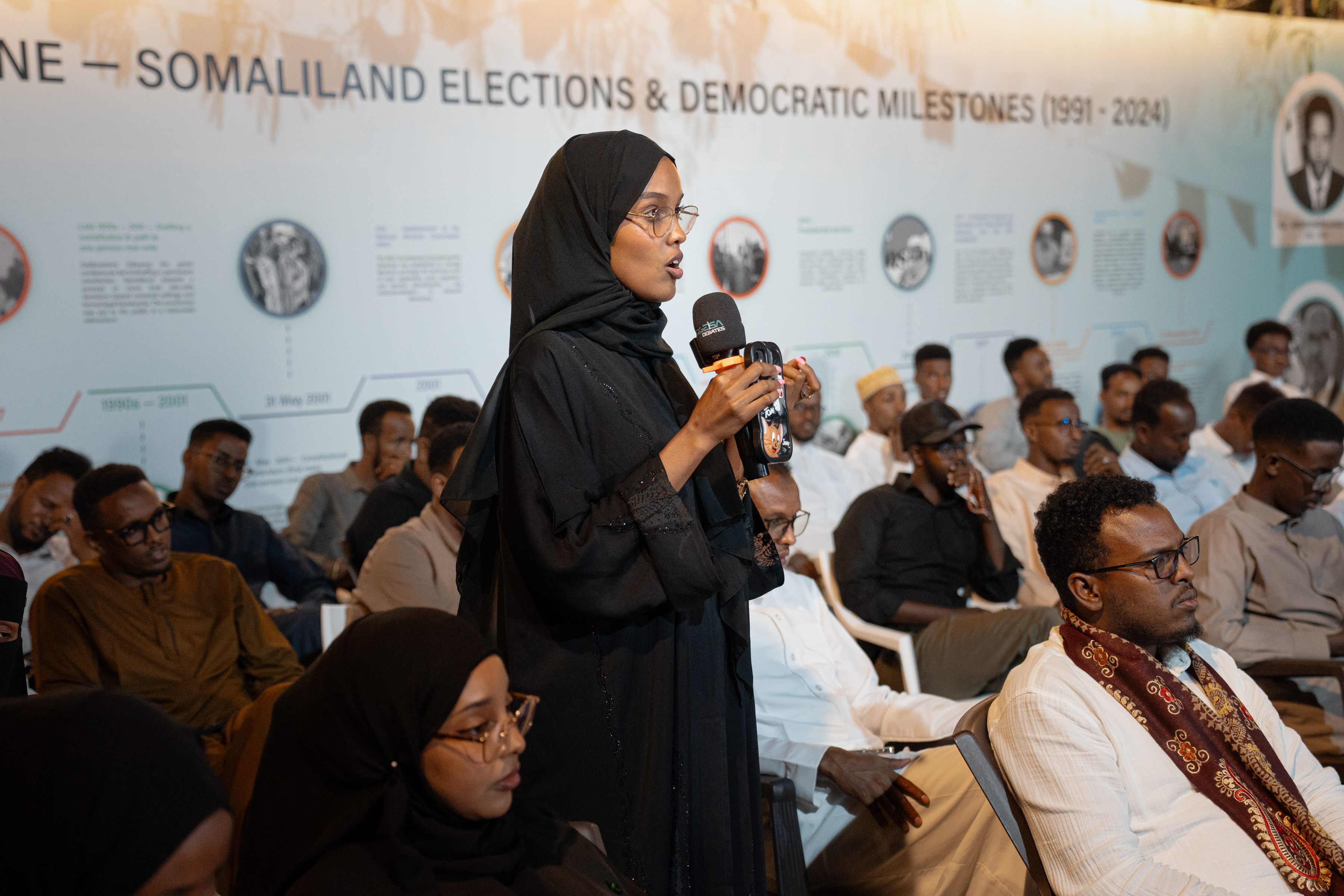 A woman contributing a question during the debate