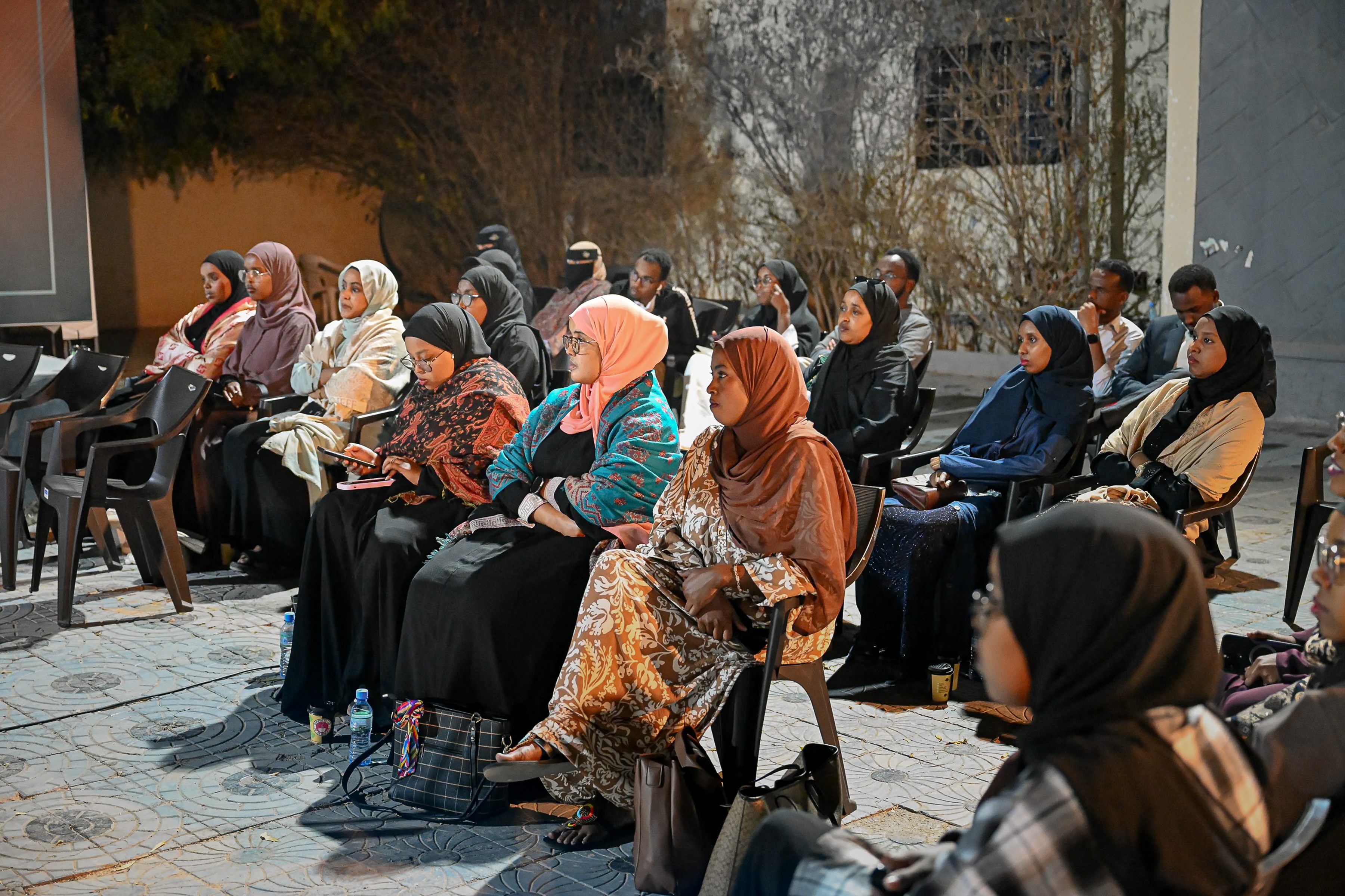 Women attending an evening community debate