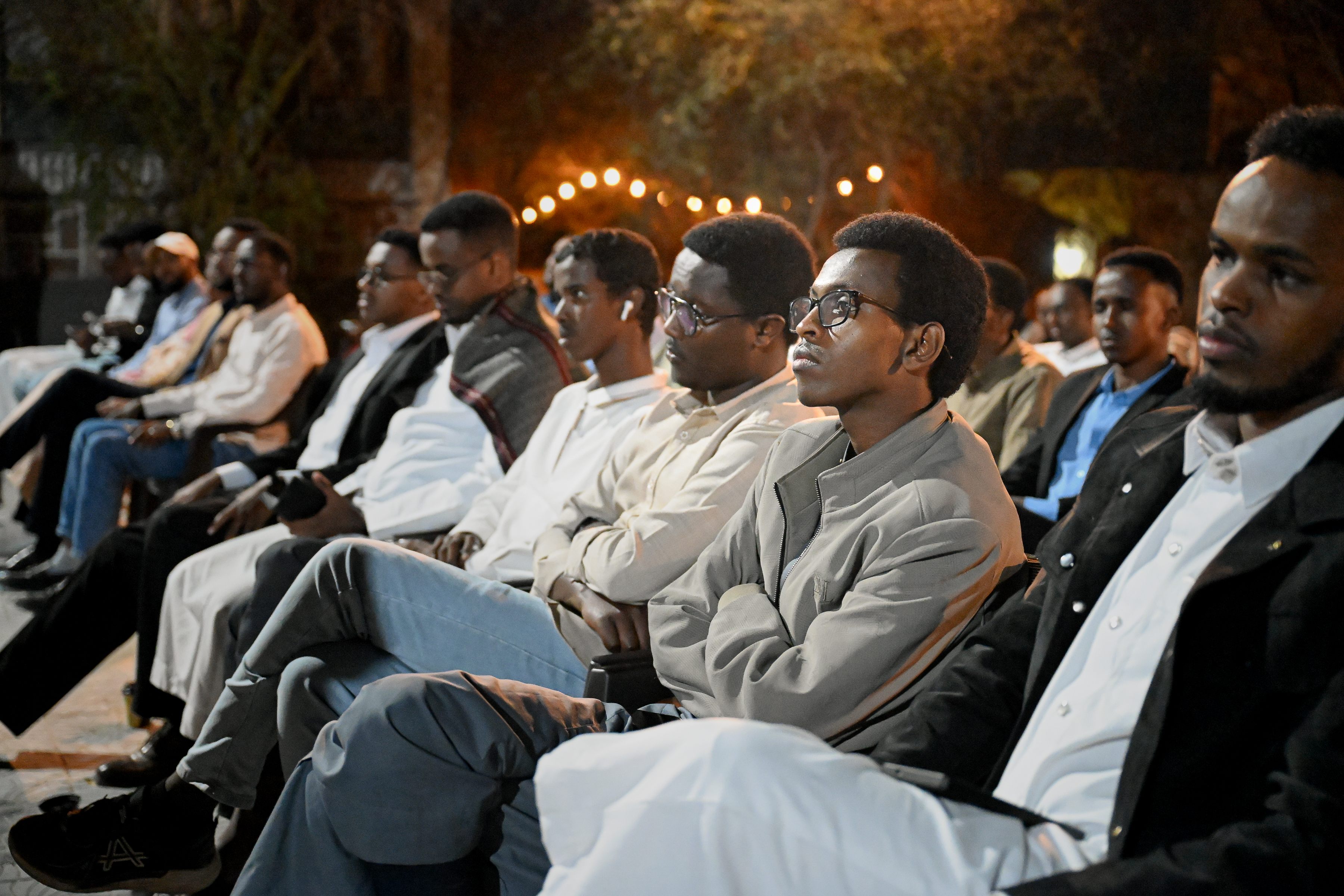 Audience members listening attentively during the debate