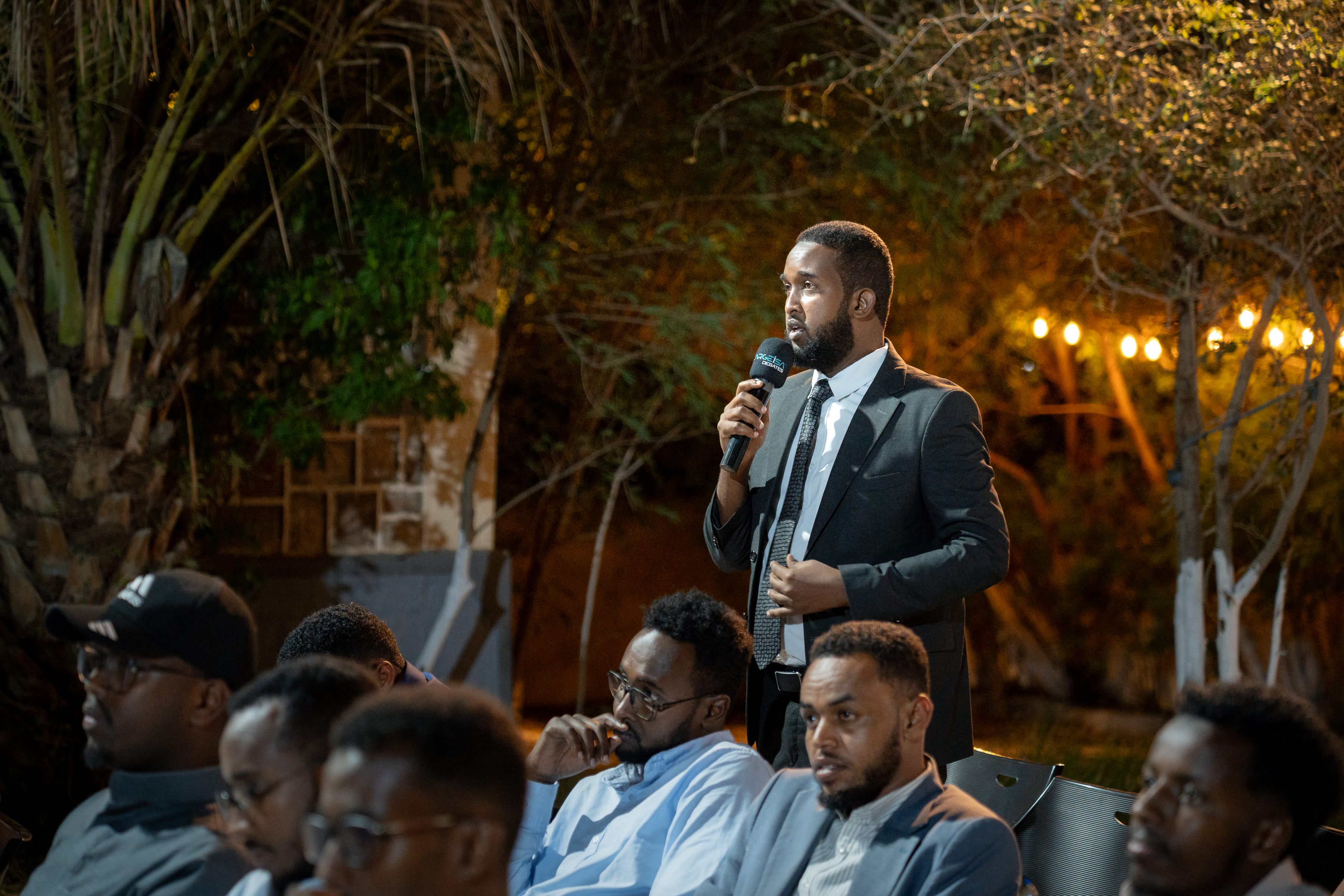 An audience member speaking during the public discussion