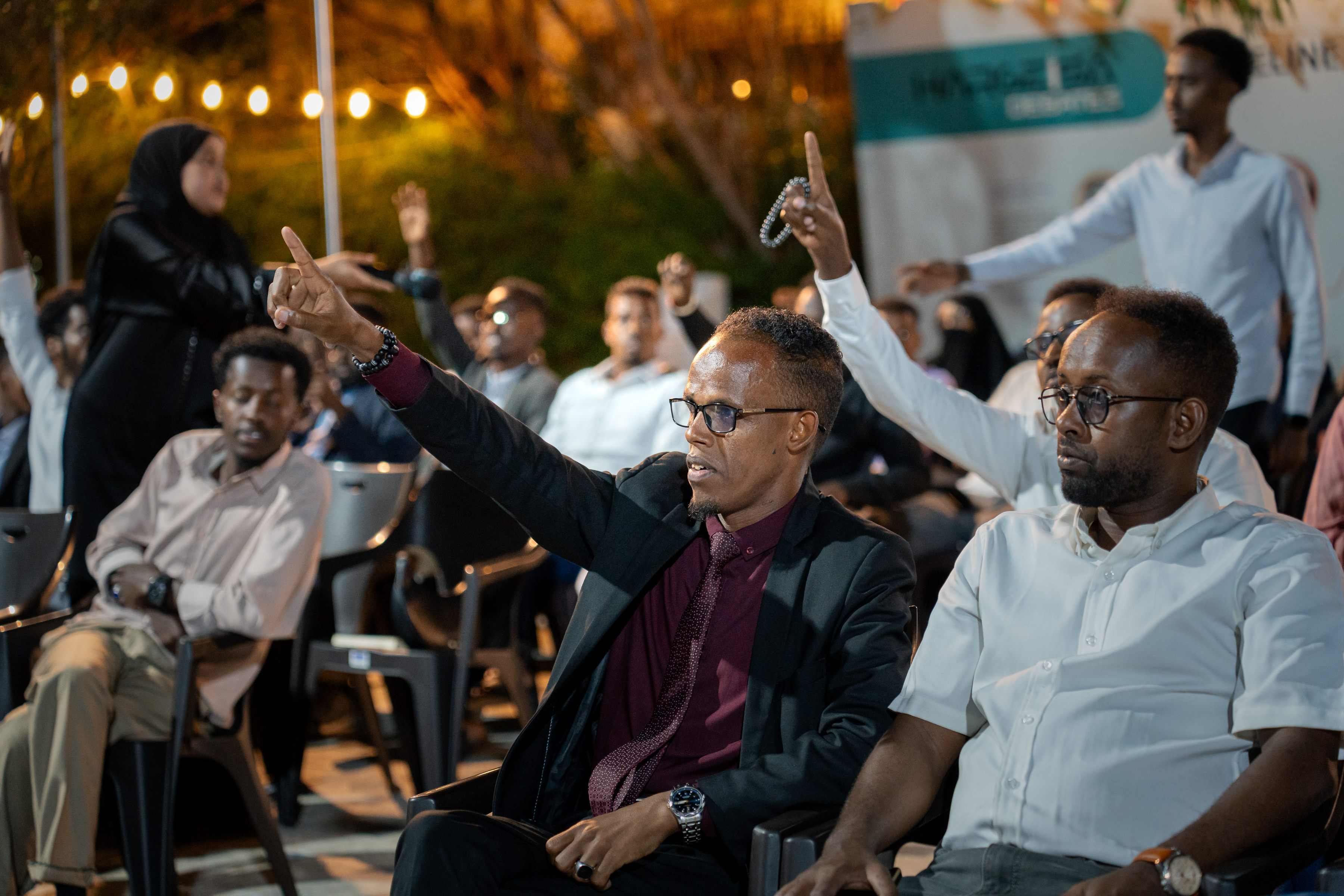 A participant raising his hand to contribute to the discussion