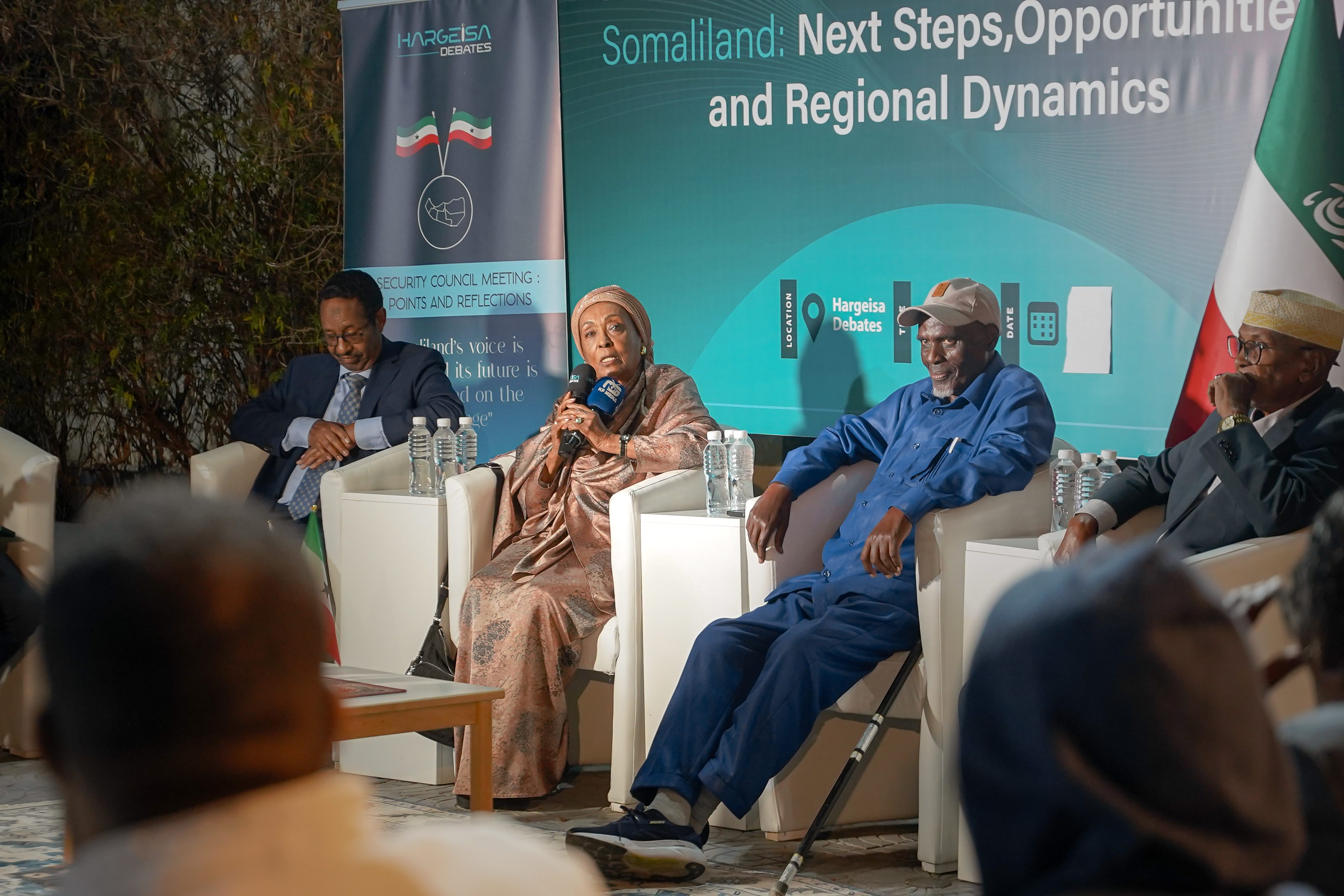 Senior panelists speaking during a regional policy discussion