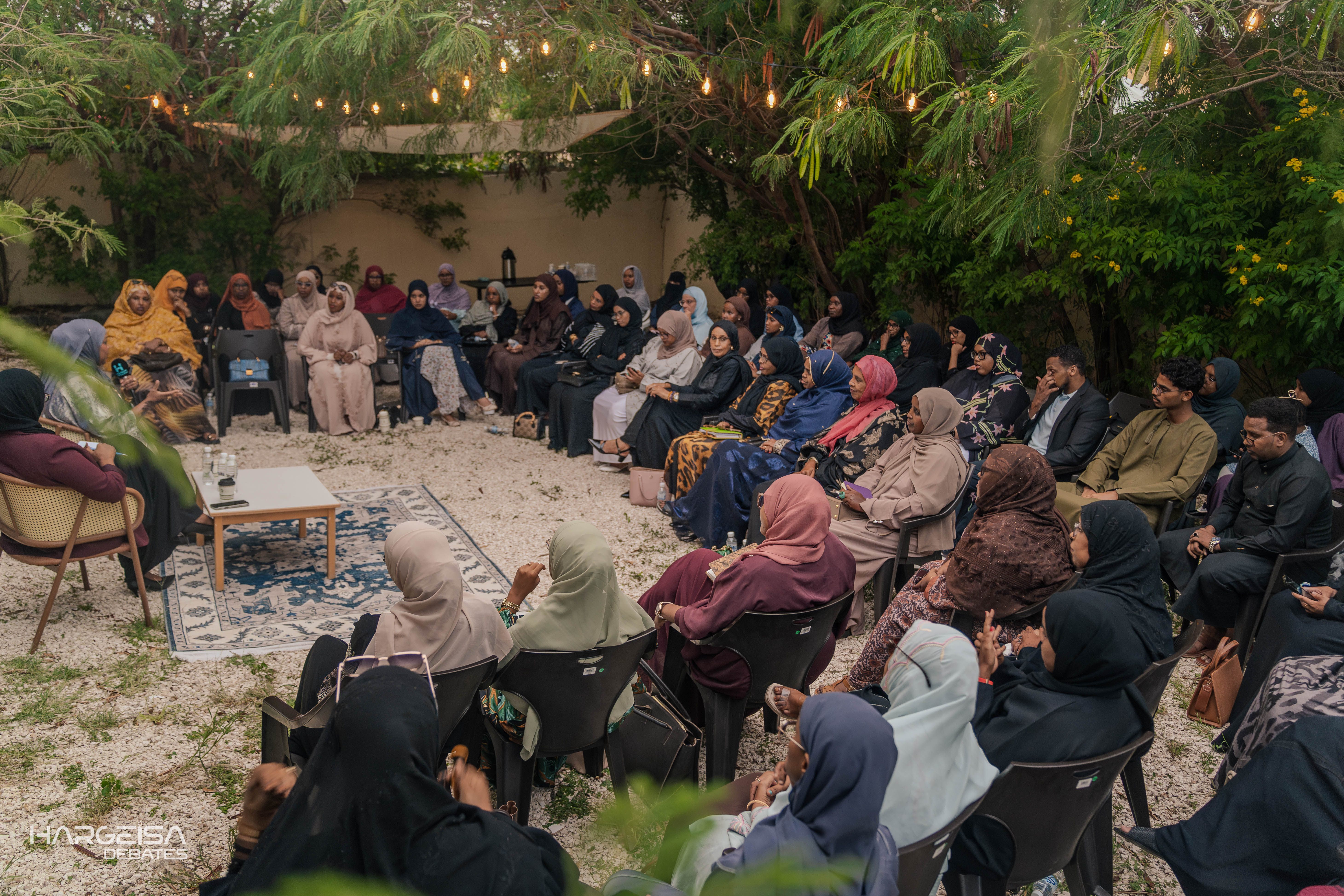 Women gathered for an outdoor community roundtable