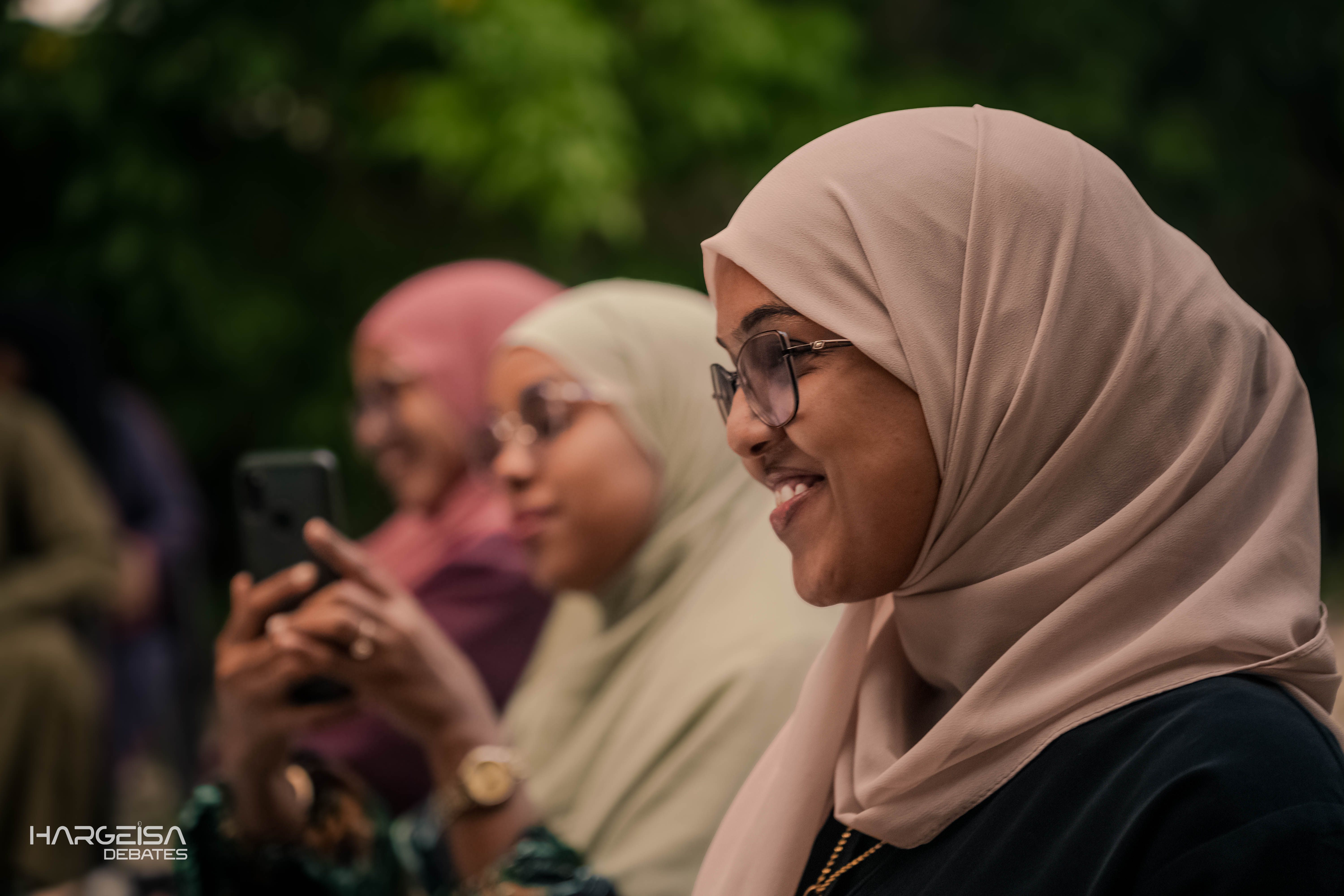 A participant smiling during a community discussion